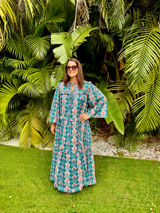 Woman in a floral dress standing in front of tropical plants